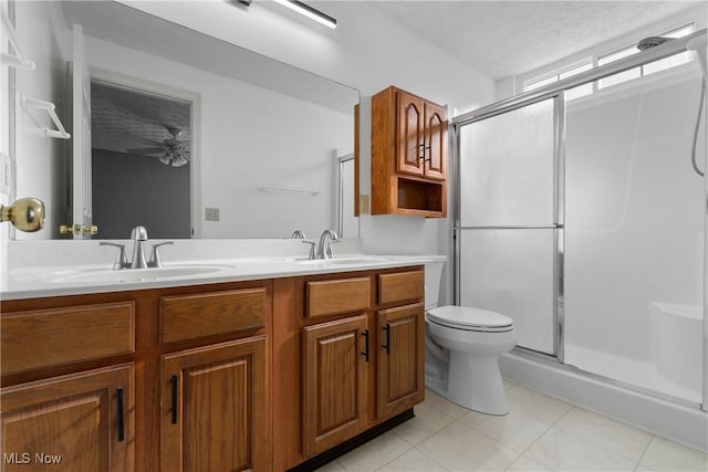 bathroom featuring a shower with shower door, a textured ceiling, toilet, and vanity