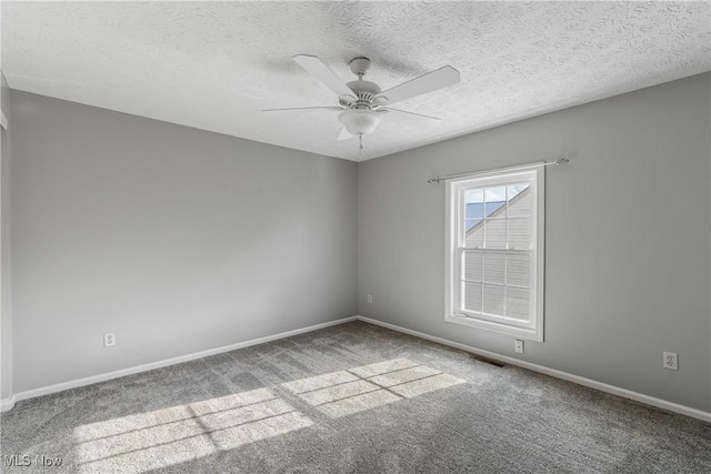 carpeted empty room featuring a textured ceiling and ceiling fan