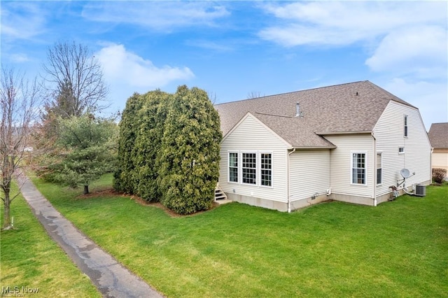 2834 Caxton Cir, Akron, OH 44312 - rear view of property with a lawn, central AC, and a shingled roof