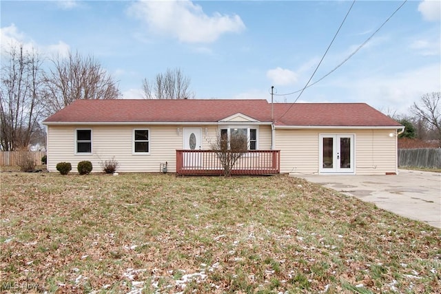 back of house featuring a lawn, french doors, and a deck