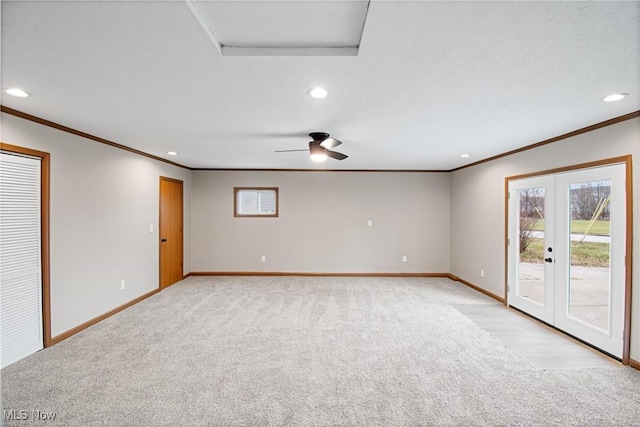 empty room with ornamental molding, light colored carpet, and french doors