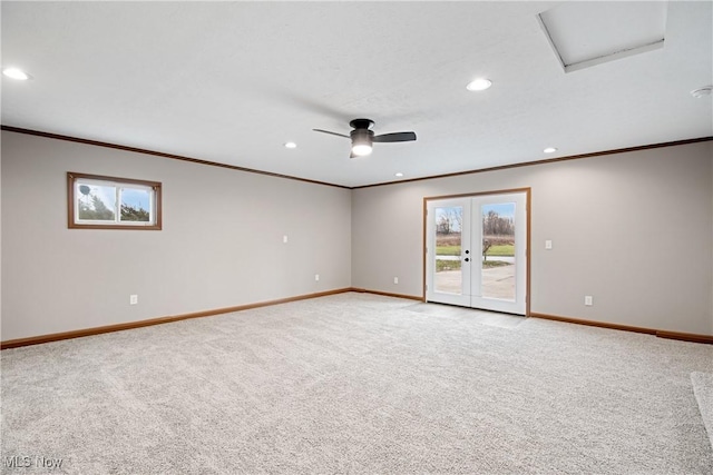 carpeted empty room featuring ceiling fan, crown molding, and french doors