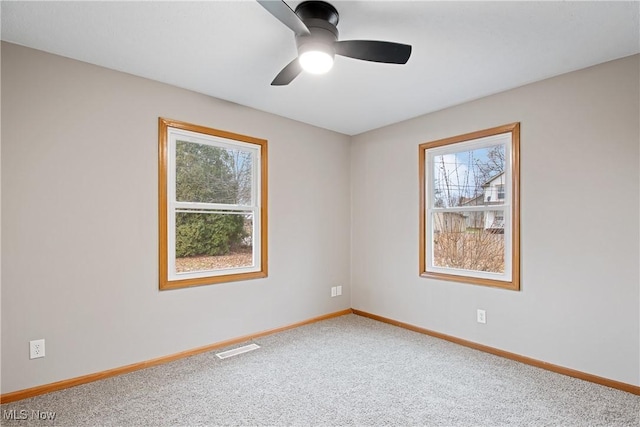 empty room featuring ceiling fan and carpet floors