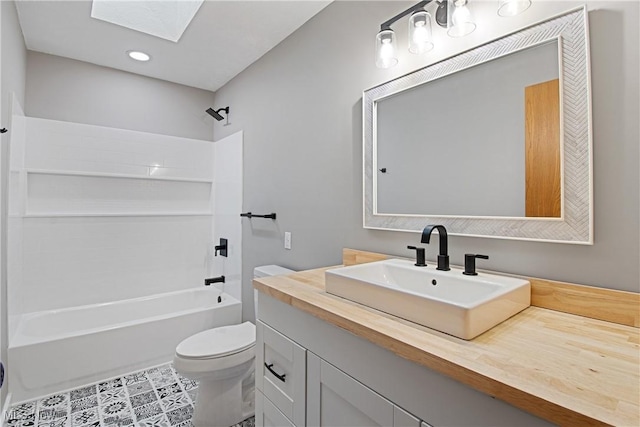 full bathroom featuring toilet, a skylight, shower / washtub combination, tile patterned floors, and vanity