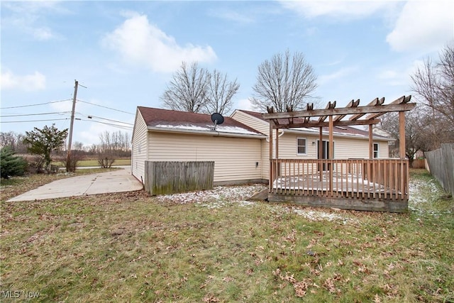 back of house with a patio area, a deck, a lawn, and a pergola