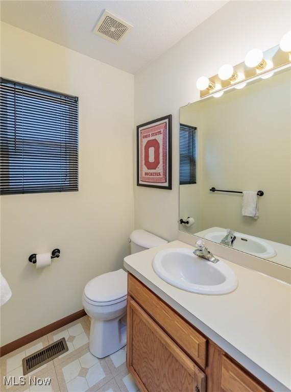 bathroom with toilet and vanity