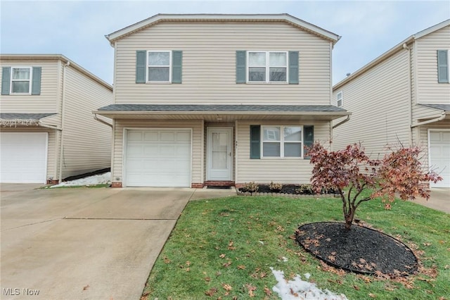 view of property with a front yard and a garage