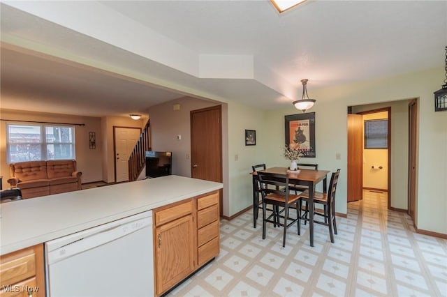 kitchen with hanging light fixtures, light brown cabinets, and dishwasher