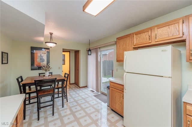 kitchen featuring decorative light fixtures and white fridge