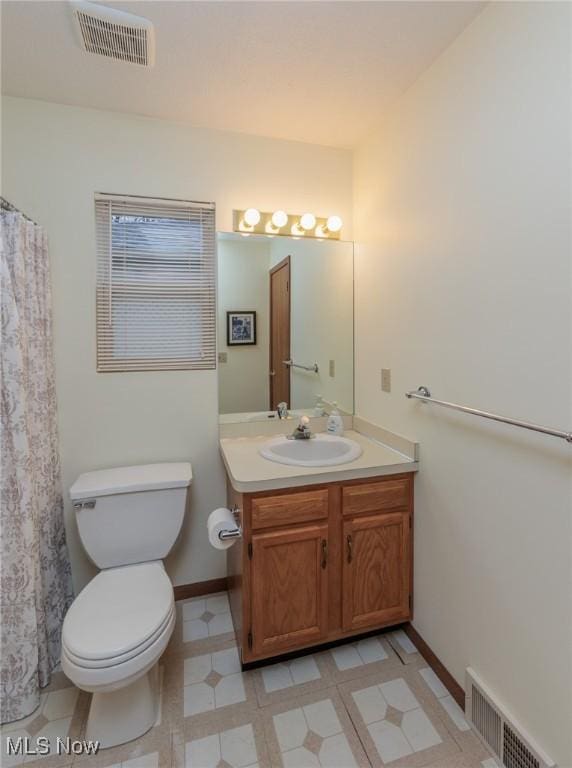 bathroom featuring toilet and vanity