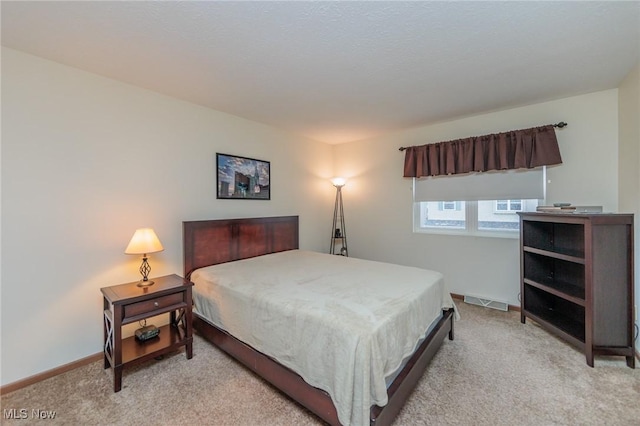 bedroom featuring light carpet