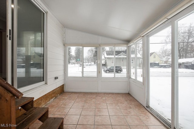 unfurnished sunroom featuring plenty of natural light and lofted ceiling