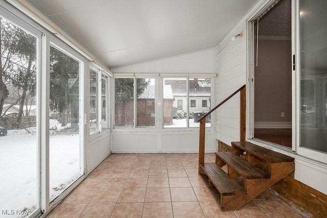 unfurnished sunroom with plenty of natural light and vaulted ceiling