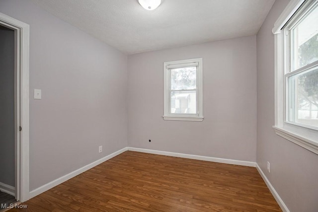 unfurnished room with hardwood / wood-style floors