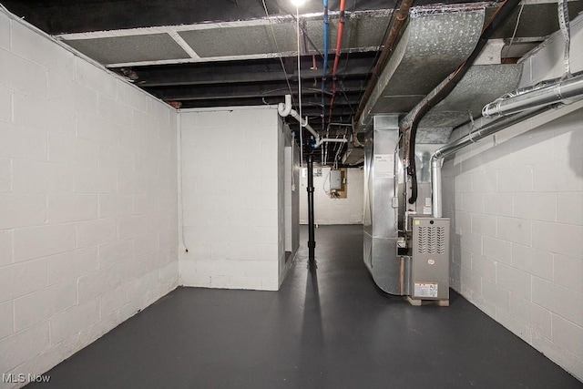 basement with electric panel and heating unit