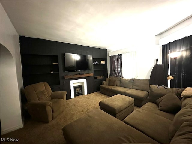 living room featuring carpet floors and built in shelves