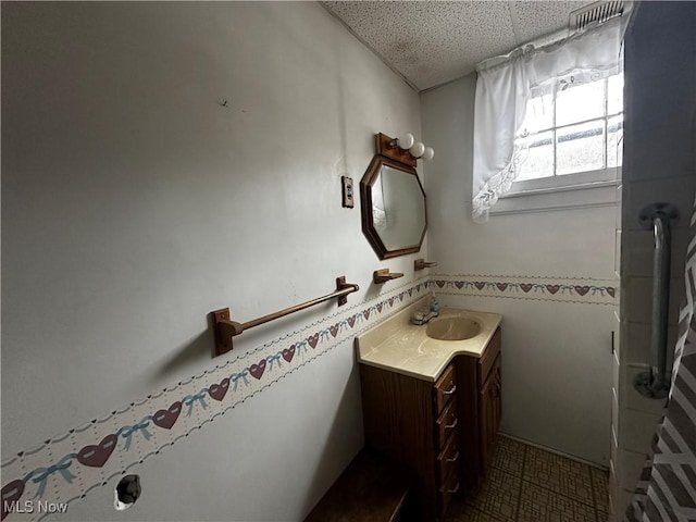 bathroom with vanity and a drop ceiling