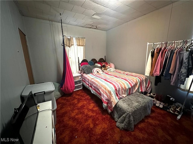 bedroom with dark colored carpet