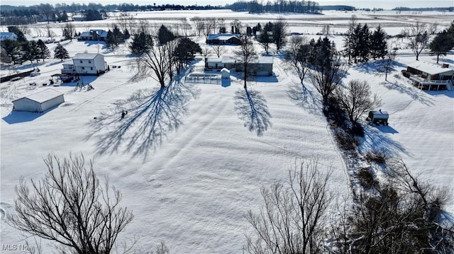 snowy aerial view featuring a rural view