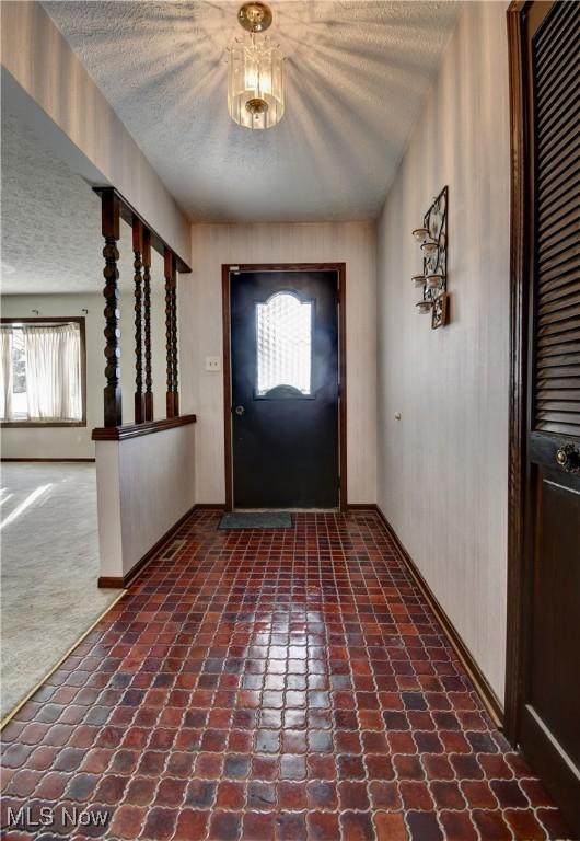 view of carpeted foyer entrance