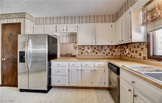 kitchen featuring decorative backsplash, sink, stainless steel appliances, a textured ceiling, and white cabinets