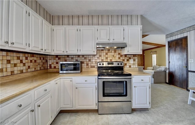 kitchen with white cabinets, a textured ceiling, stainless steel appliances, and range hood