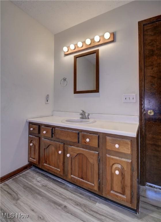 bathroom featuring vanity and hardwood / wood-style flooring