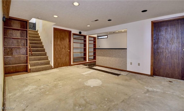 unfurnished room with concrete flooring