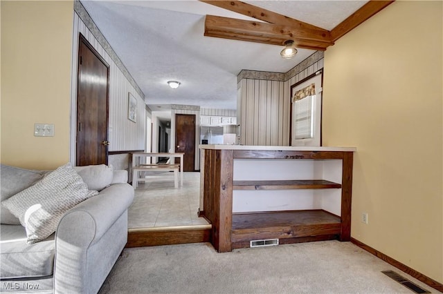 interior space with a textured ceiling and light colored carpet