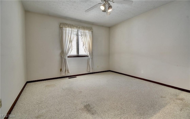 unfurnished room featuring a textured ceiling, ceiling fan, and carpet flooring