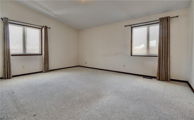 spare room featuring light colored carpet