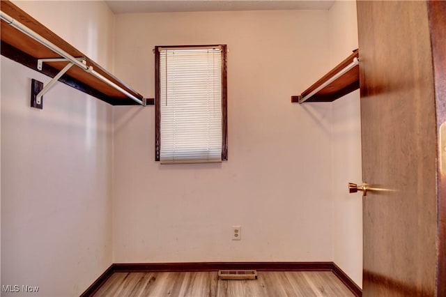 spacious closet featuring light hardwood / wood-style flooring