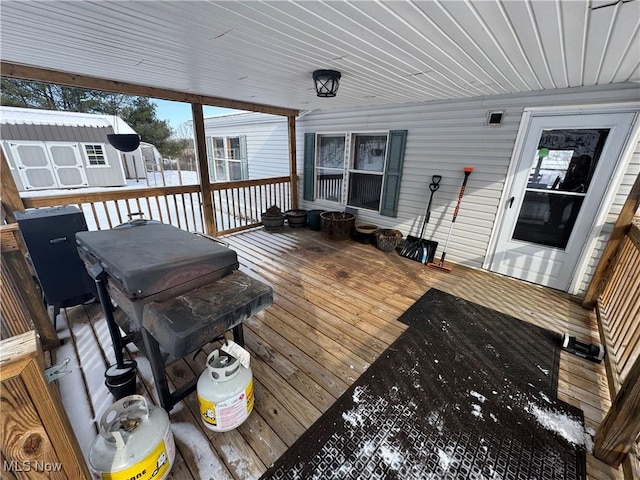 wooden terrace featuring a storage shed