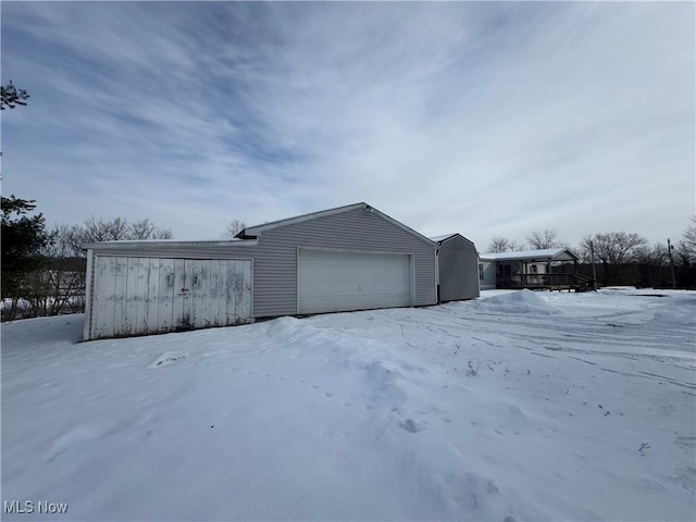 snow covered property featuring a garage