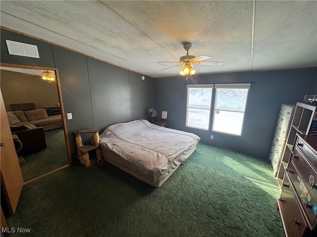 carpeted bedroom featuring ceiling fan, a closet, and a textured ceiling