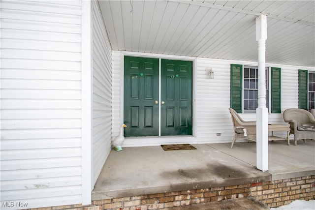 property entrance with covered porch