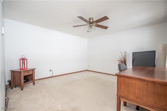 carpeted office space with ceiling fan