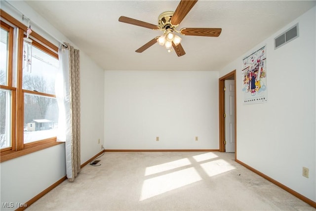 unfurnished room featuring light carpet