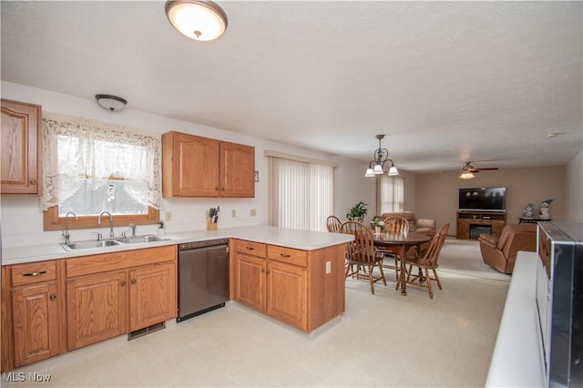 kitchen featuring dishwasher, sink, hanging light fixtures, ceiling fan, and kitchen peninsula