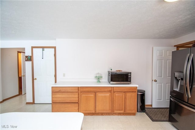 kitchen featuring appliances with stainless steel finishes and a textured ceiling