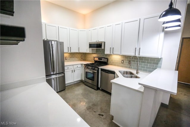 kitchen with decorative light fixtures, white cabinetry, sink, decorative backsplash, and stainless steel appliances