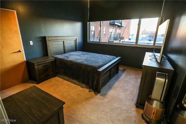 bedroom featuring light colored carpet