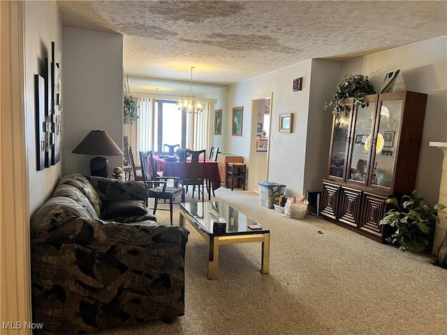 living room with a textured ceiling, a chandelier, and carpet flooring