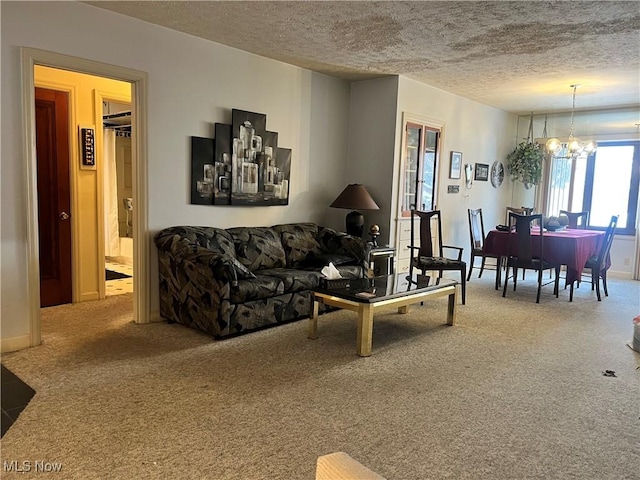 carpeted living room featuring a textured ceiling and a notable chandelier