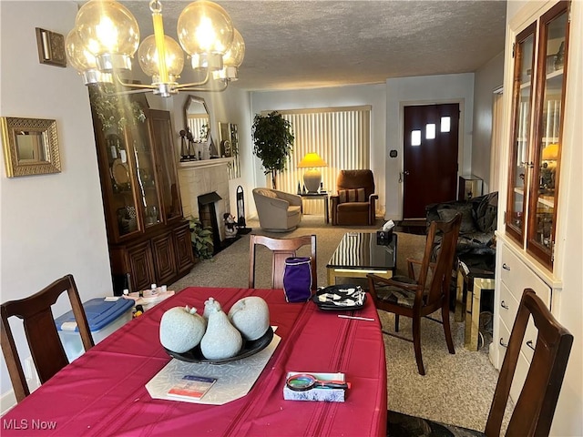 dining space featuring a chandelier, a textured ceiling, and carpet flooring