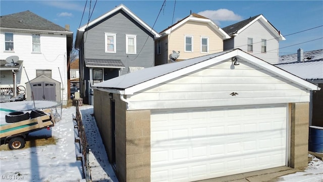 view of front of property with a garage and an outdoor structure