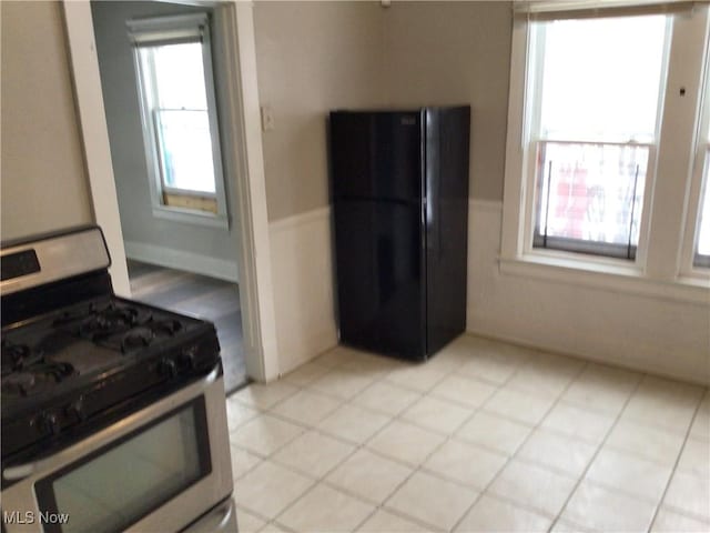 kitchen featuring black refrigerator and gas range