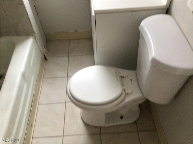 bathroom featuring toilet and tile patterned flooring