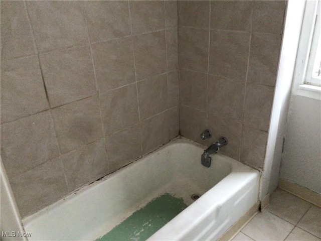 bathroom with a tub to relax in and tile patterned flooring