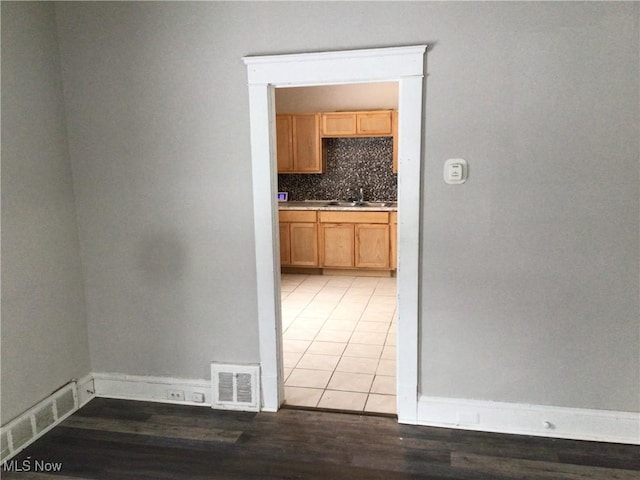 hall featuring sink and hardwood / wood-style floors